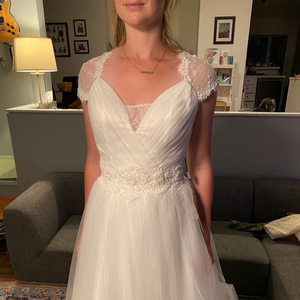 Beautiful delicate wedding dress. NEVER WORN!